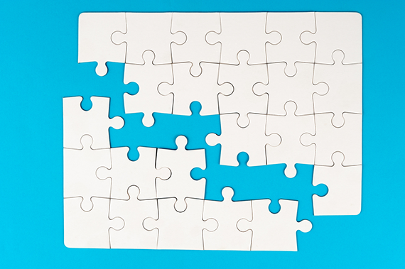 White puzzle pieces on a blue background