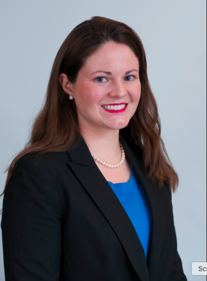 Headshot of a dark-haired woman in a blazer.