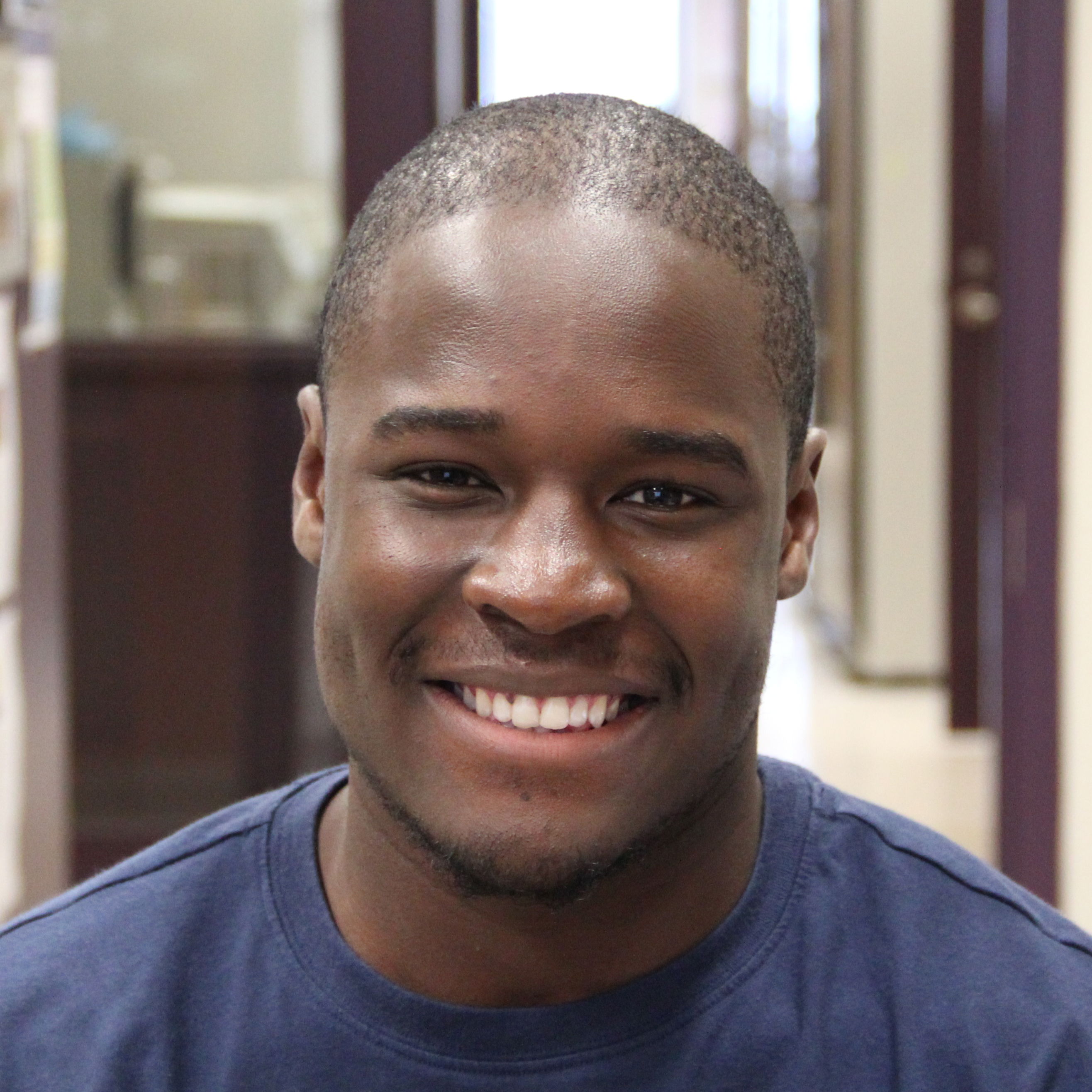 Headshot of a man in a black t-shirt.