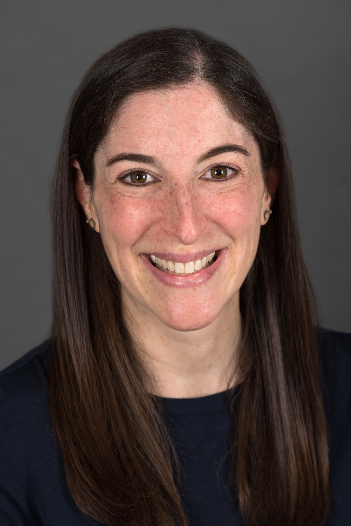 Headshot of a woman with dark hair.