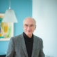 Gerry Fink stands smiling, one hand in his pocket. 