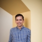 Sebastian Lourido stands smiling in an alcove.