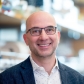 Jonathan Weissman stands smiling in the lab. 