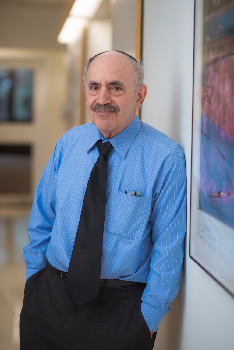 Robert Weinberg stands in a hallway, hands in his pockets.