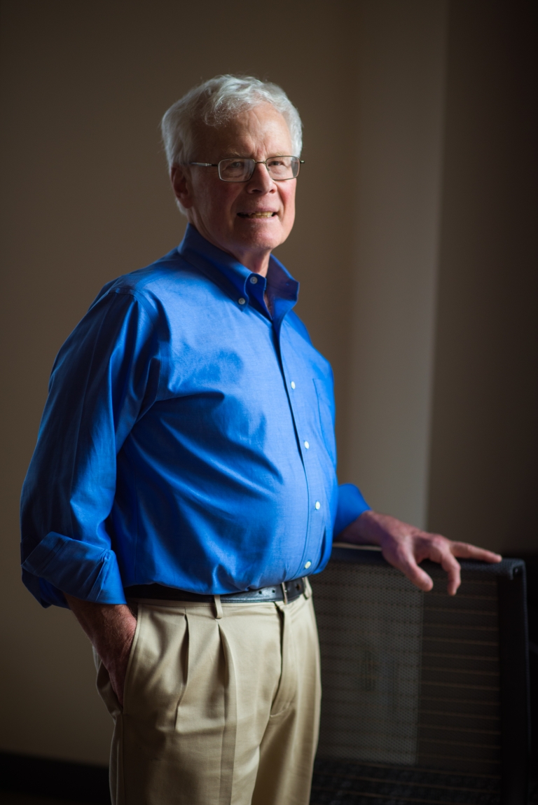 Harvey Lodish stands smiling with one hand in his pocket.