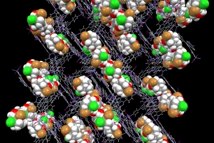 Brightly colored molecules represented by dots held within the lattice-like framework of the crystalline sponge. 
