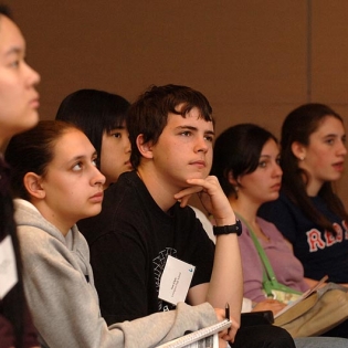 Five students looking up at a presentation.