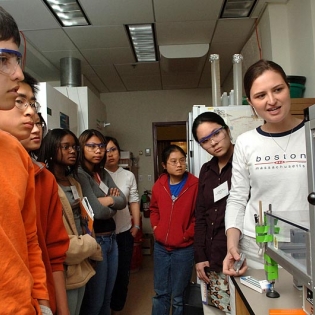 Students examine machinery in the lab.