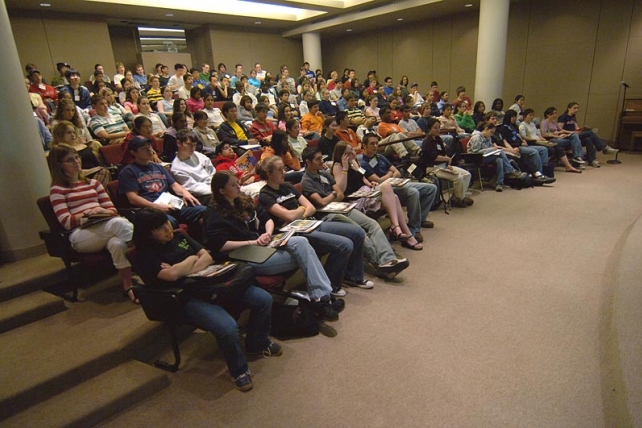 Students sitting in a small auditorium for a lecture.