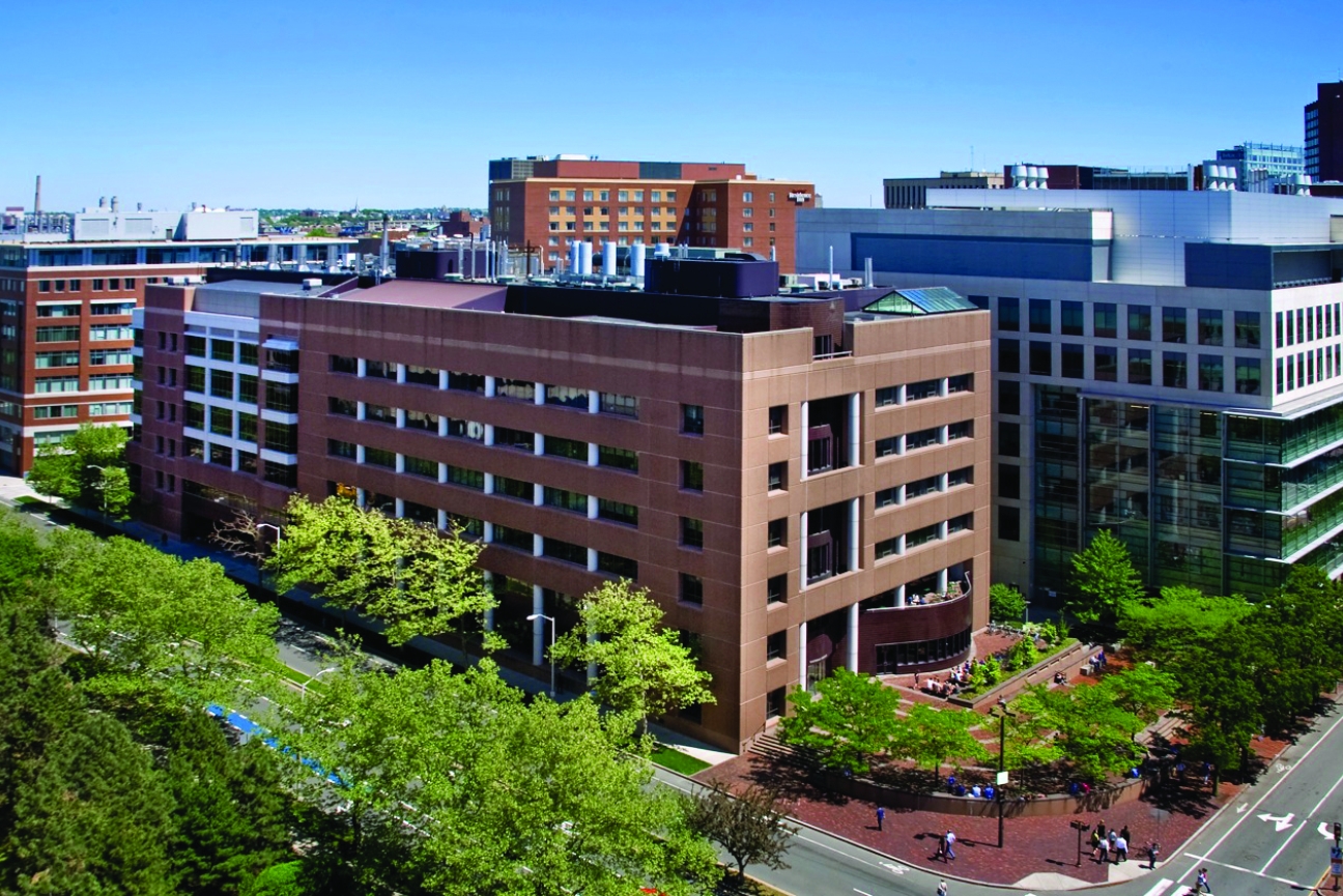 A long red brick building seen from the air.