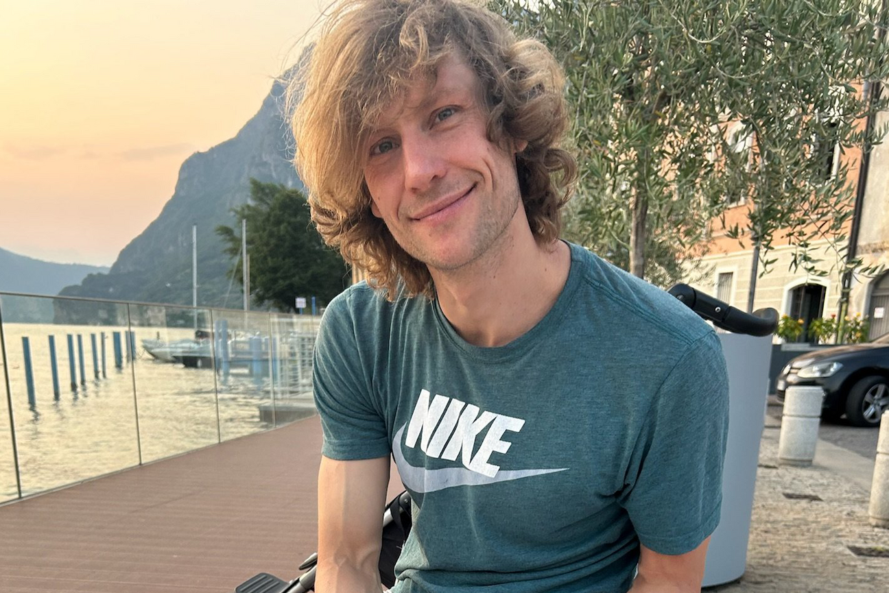 Close up of Christoph Gäbelein in front of some water and trees