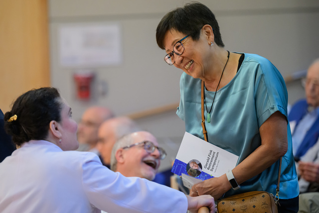 Two women speaking and smiling in the audience
