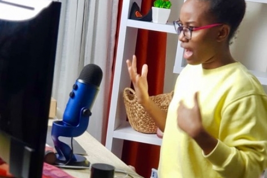Brittania sitting at her desk, teaching via videochat